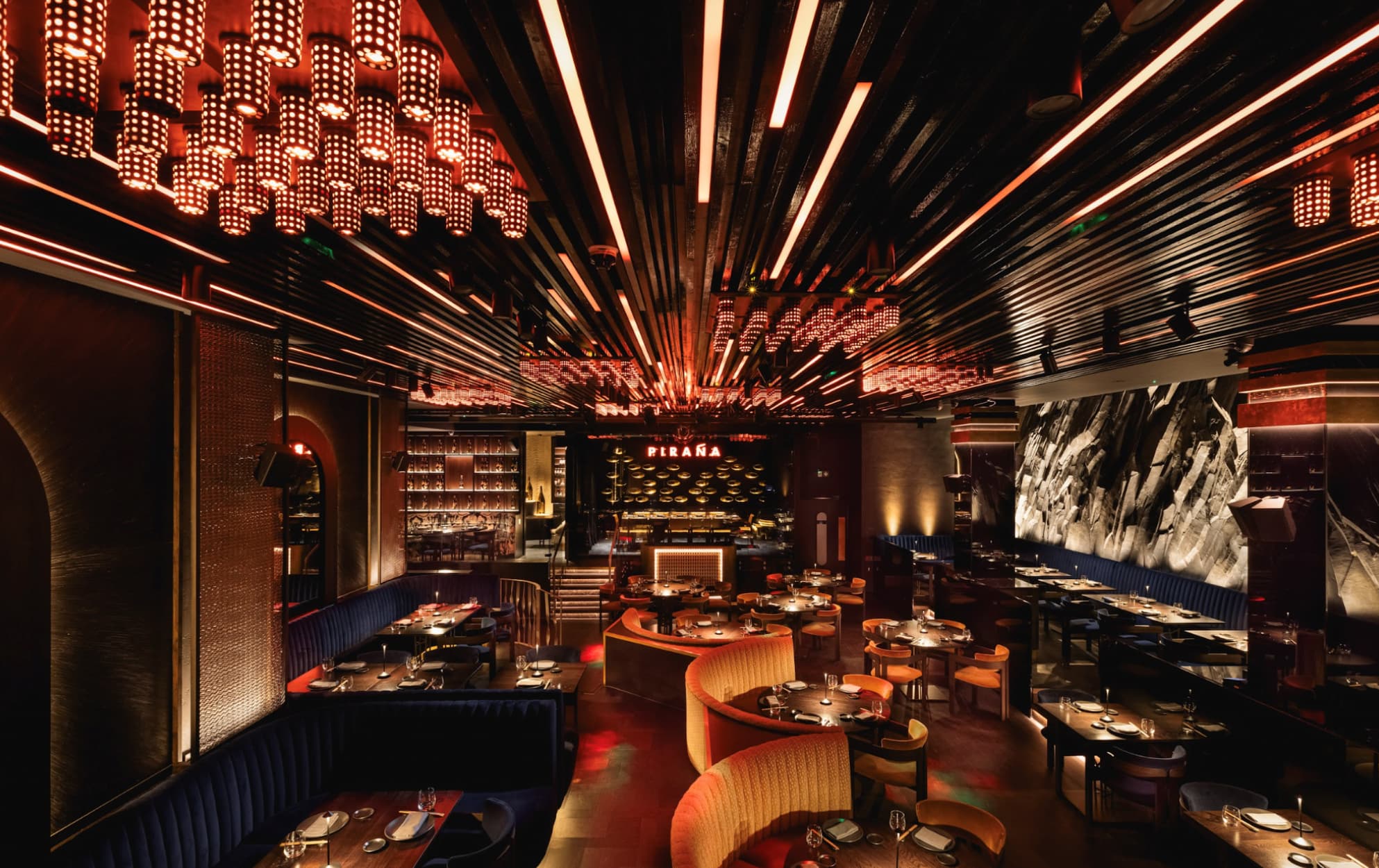 Vibrant Piraña Main Dining Room with elegant chandelier, ideal for events and private dinners.