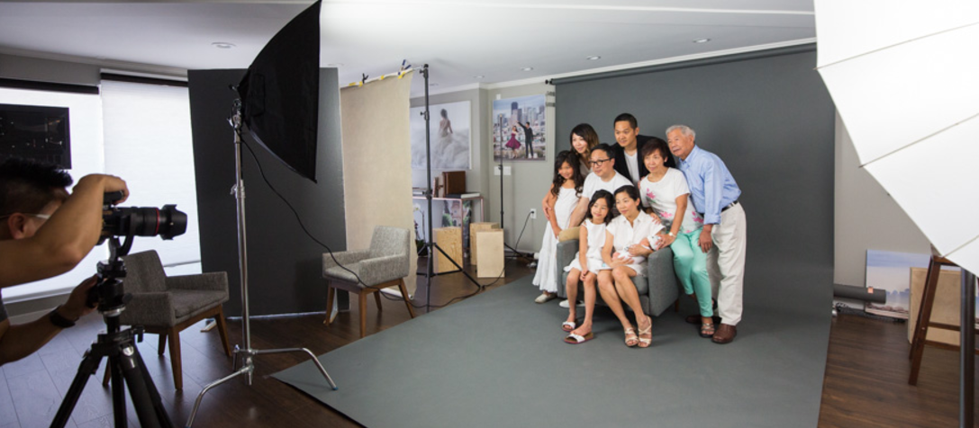 Family portrait session in neutral backdrop, ideal for relaxed event photography.