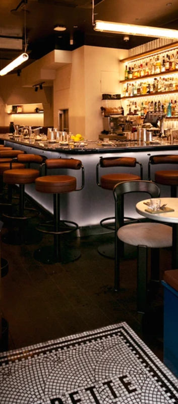 Stylish cocktail bar with sleek stools, perfect for receptions and networking events.