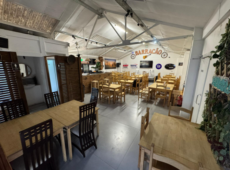 Versatile event space with wooden furniture, perfect for social gatherings and meetings.