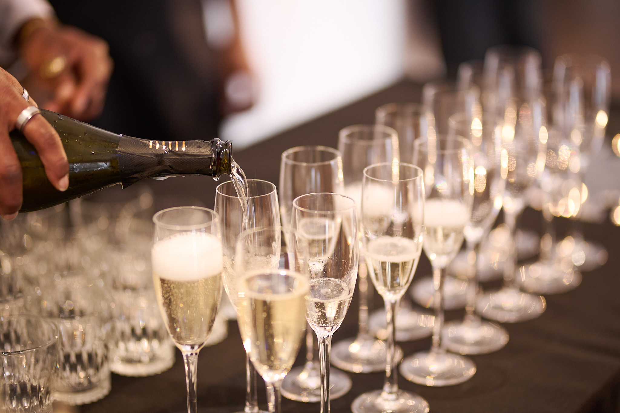 Elegant champagne pouring in OXO2's West Wing for a sophisticated celebration event.