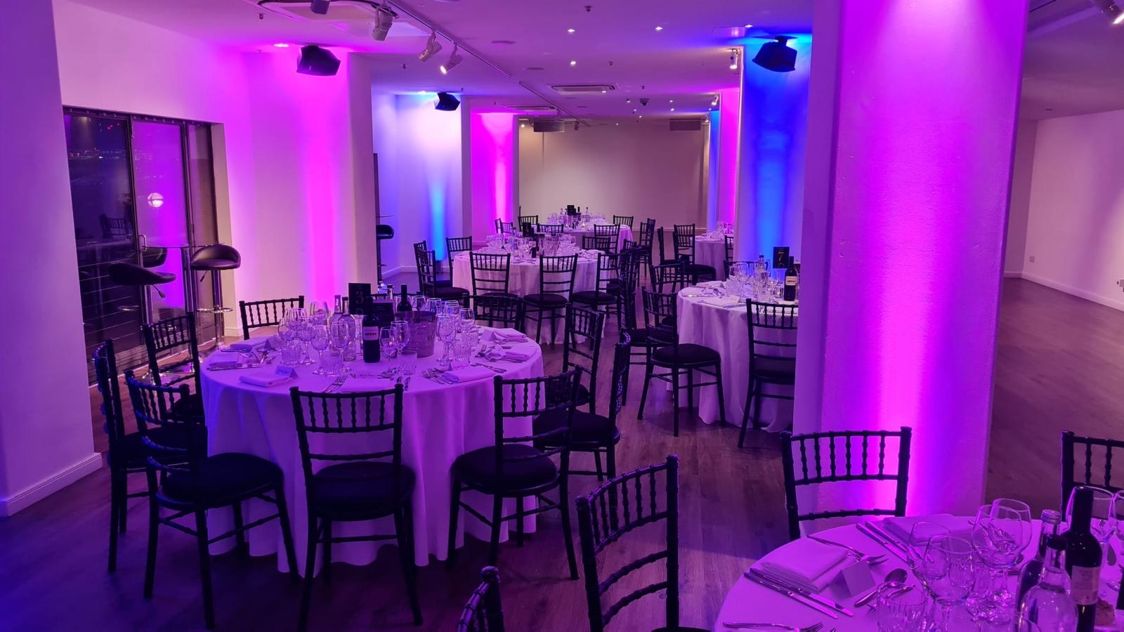 Elegant event space in OXO2 with round tables, ideal for weddings and corporate events.