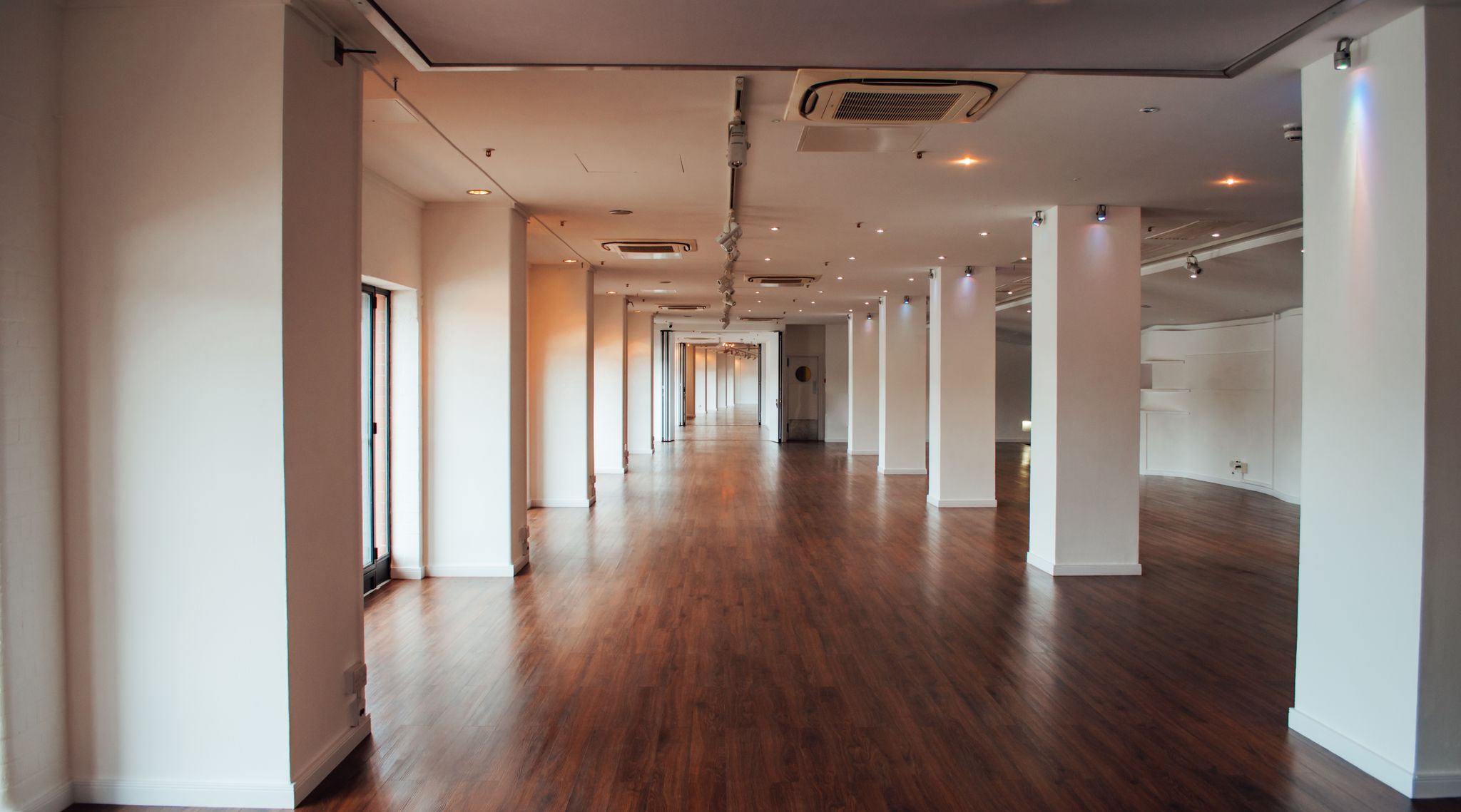 Spacious West Wing venue in OXO2 with polished wooden floors, ideal for events.