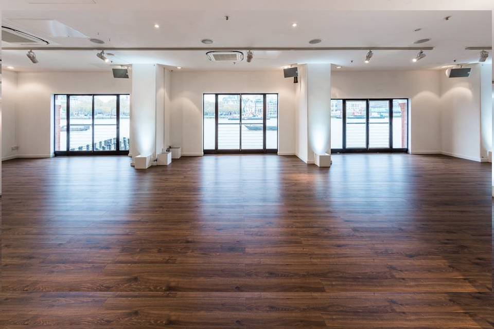 Spacious West Wing venue with large windows, ideal for corporate events and weddings.