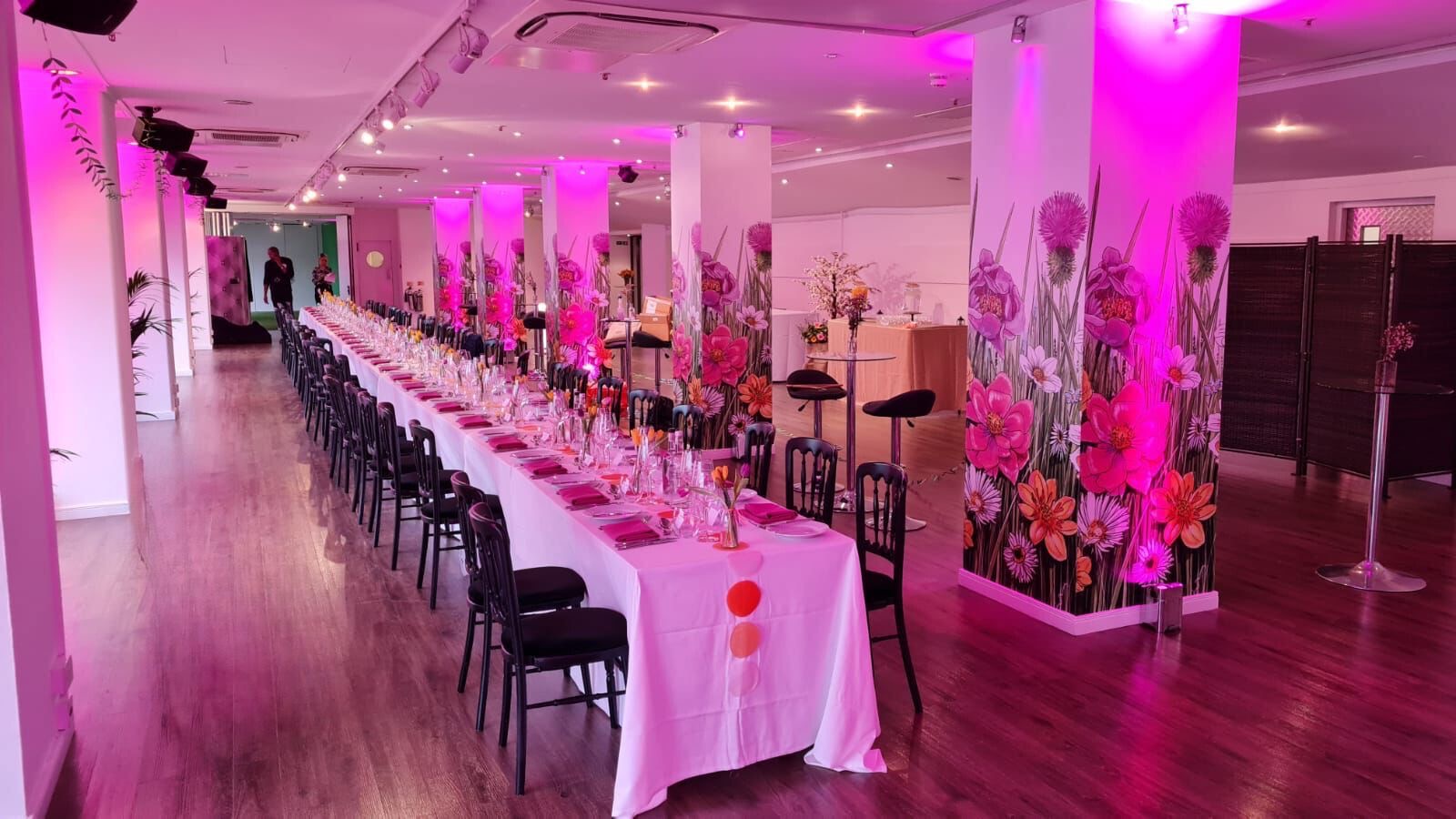 Elegant event space in OXO2 with floral decor, perfect for formal dinners and networking.