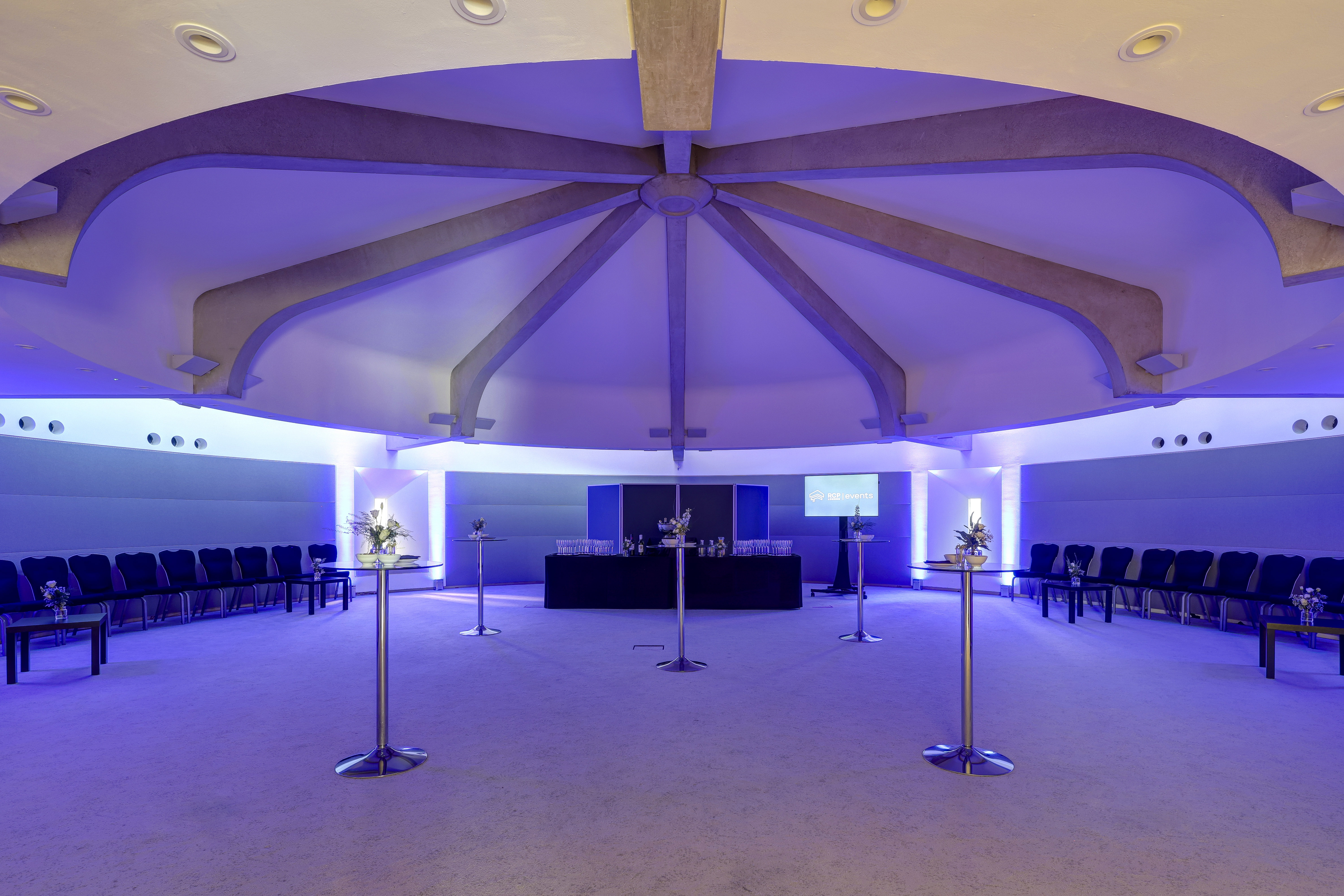 Modern Council Chamber in RCP London Events, featuring circular seating and ambient blue lighting.