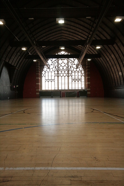Spacious Sports Hall with polished wooden floor, ideal for events and workshops.