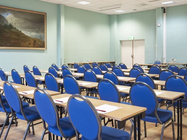 Olavsalen meeting space at Clarion Hotel® The Hub, featuring blue chairs for workshops.