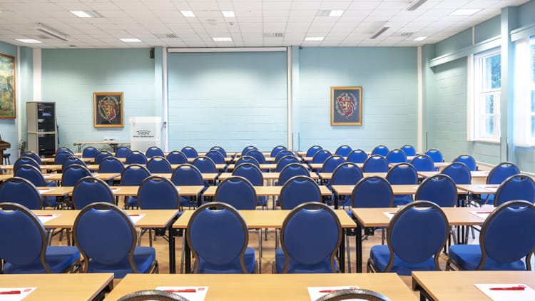 Conference room Olavsalen at Clarion Hotel, featuring blue chairs for seminars.