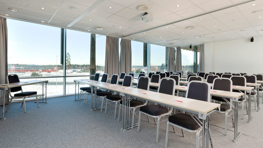 Modern conference room at Clarion Hotel® The Hub with natural light and flexible layout.