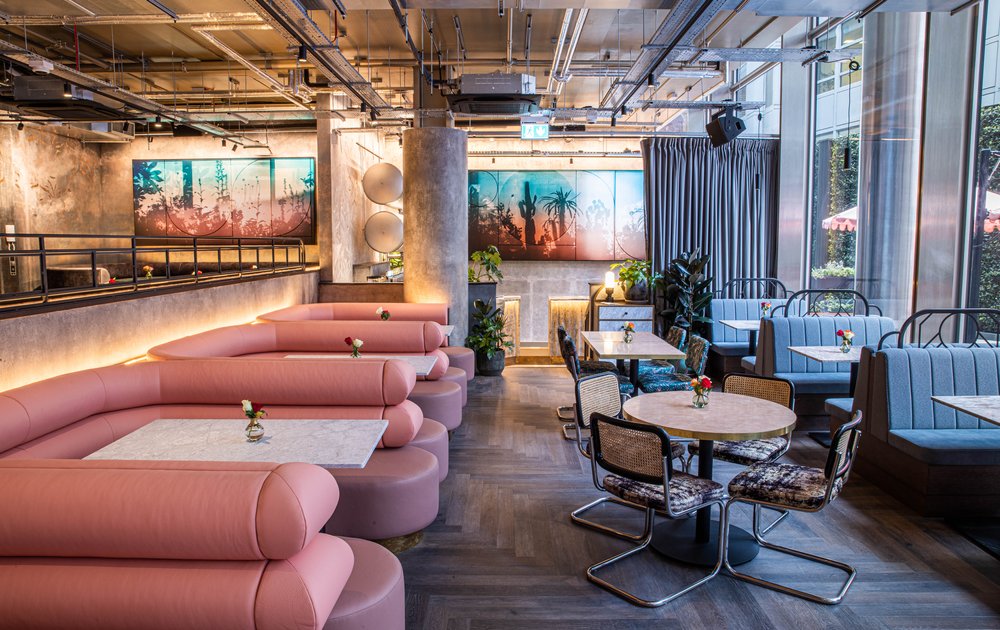 Modern event space with pink seating in Paradise Green for meetings and gatherings.