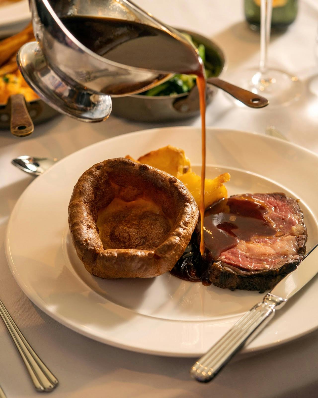 Private dining room with plated roast beef, Yorkshire pudding, ideal for events.