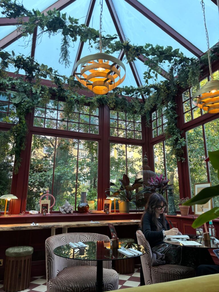 Cozy indoor cafe with large windows, perfect for small events and meetings