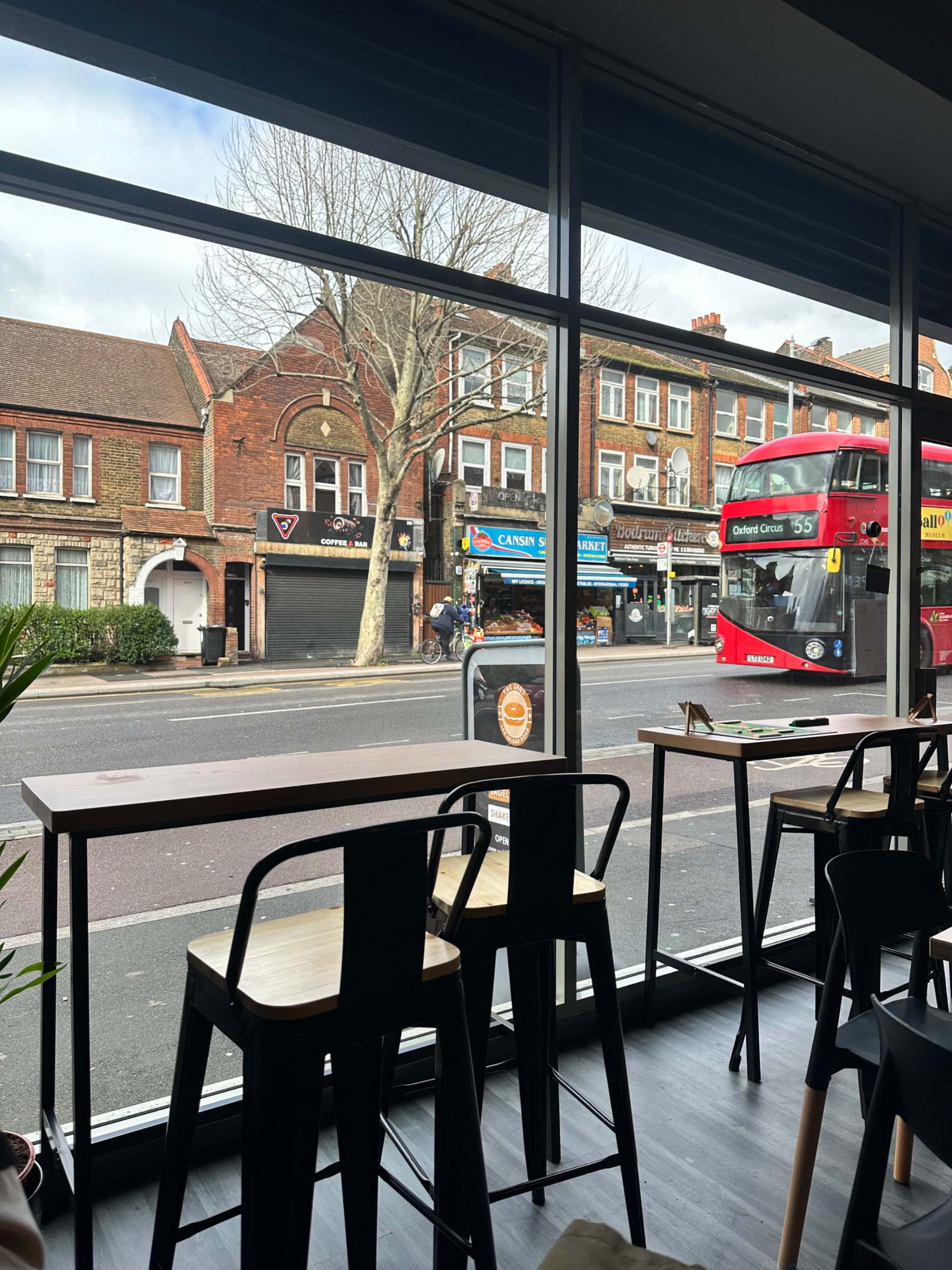 Café in The Spot with modern tables, perfect for meetings and gatherings.