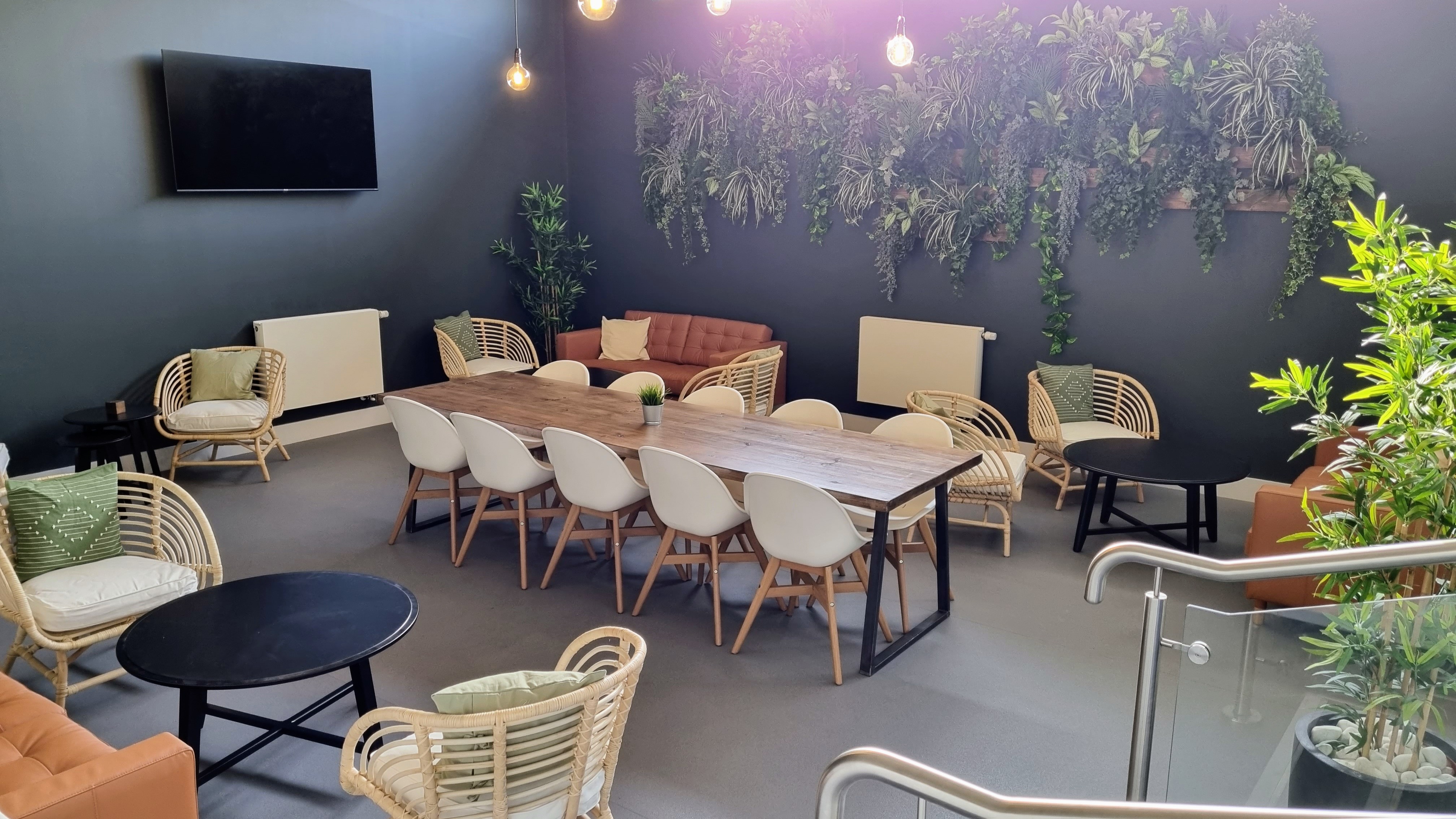 "Modern Riverside Conferencing lounge with large table for networking and brainstorming events."