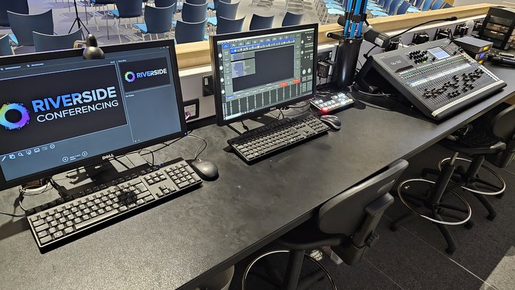 Auditorium control station with monitors ready for hybrid conferencing events.