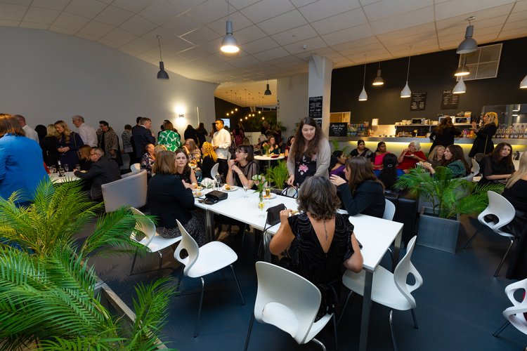 Riverside Cafe: Modern event space with greenery for social gatherings and corporate events.