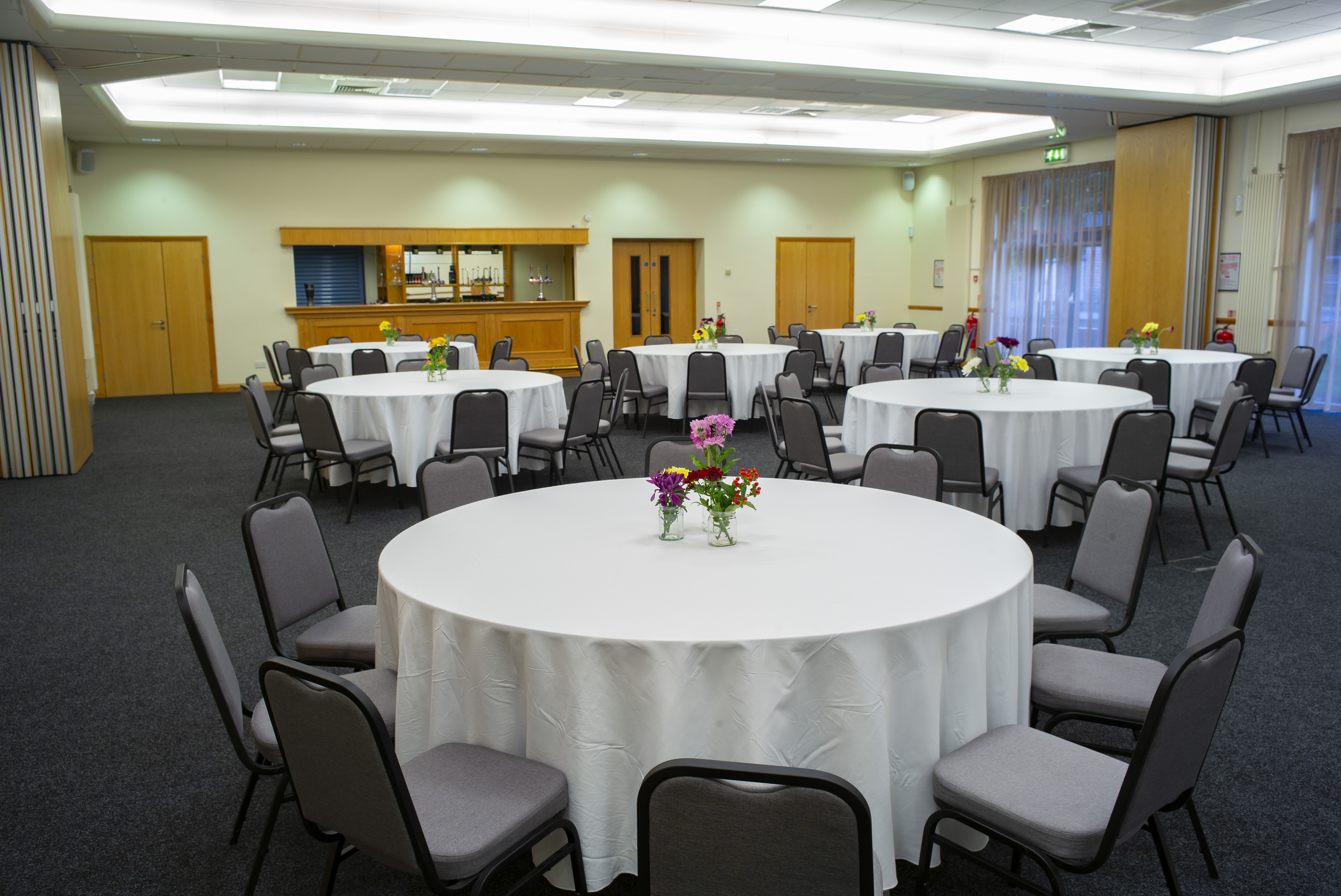 Caphouse Suite event space with round tables, ready for meetings and banquets.