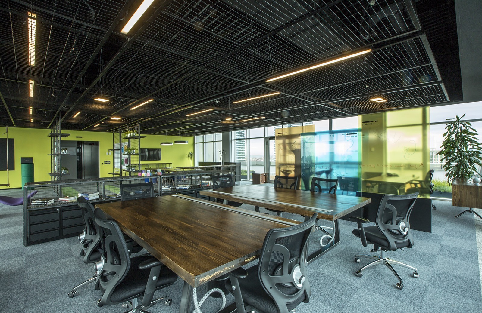 Modern private office meeting space with large table, ideal for collaboration and events.