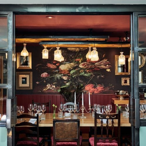 Private dining room at Brooklands Hotel with elegant floral mural, ideal for intimate events.