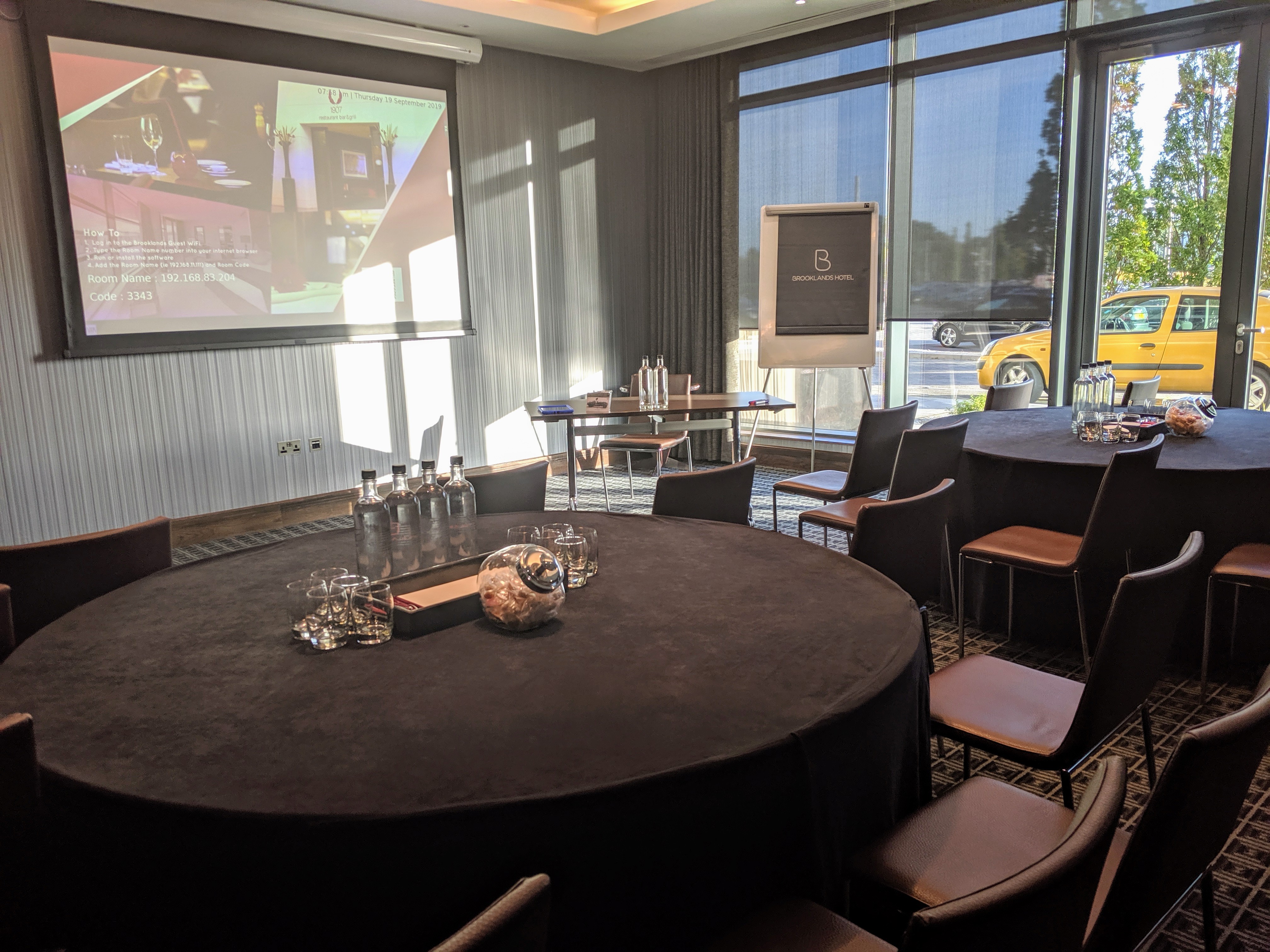 Napier Suite at Brooklands Hotel - elegant meeting space with round tables, perfect for workshops.