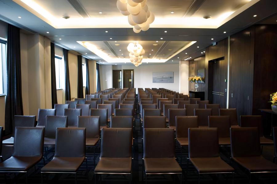 Modern conference room with sleek brown chairs at Brooklands Hotel for workshops.