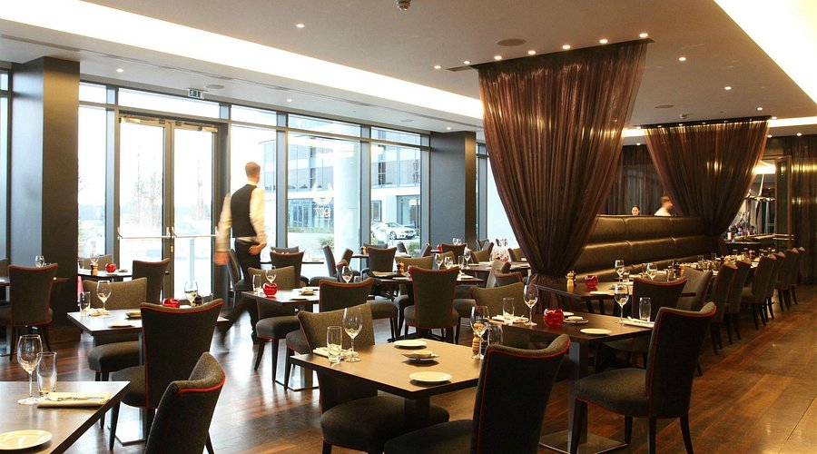 Modern restaurant with elegant tables and ambient lighting for events in Brooklands Hotel.