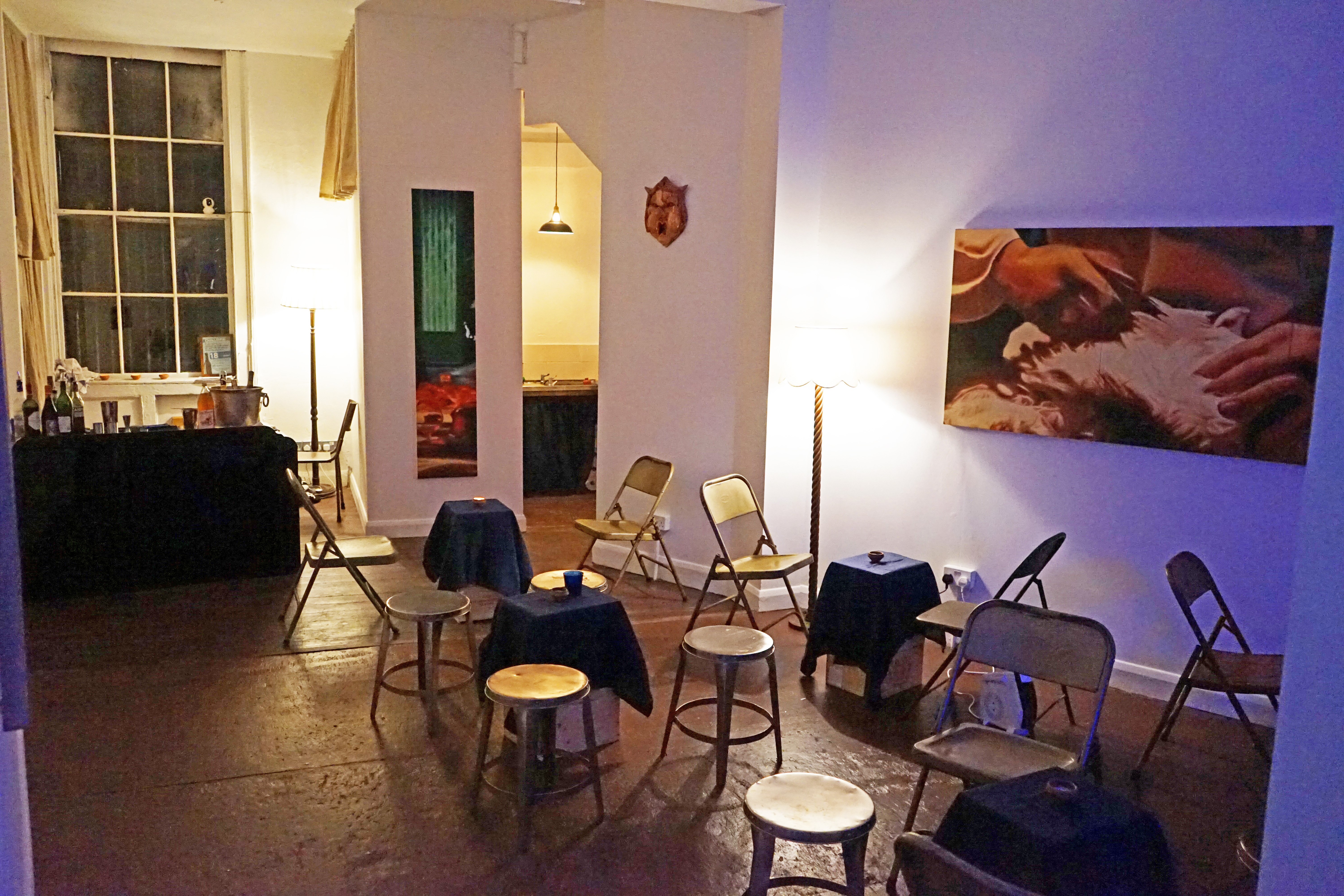 Cozy art gallery bar with soft lighting, ideal for workshops and networking events.