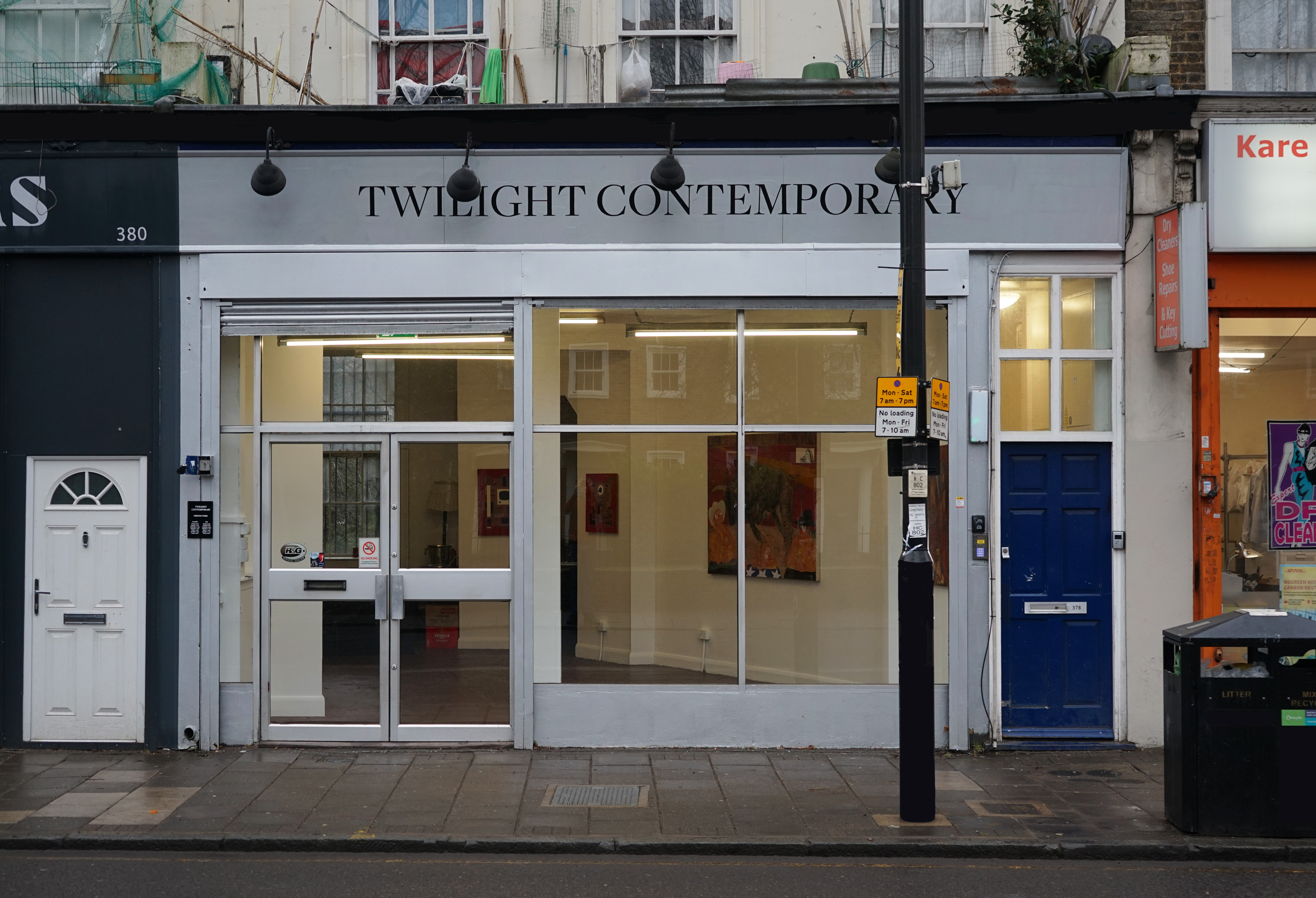 Modern art gallery with large glass windows, perfect for exhibitions and networking events.