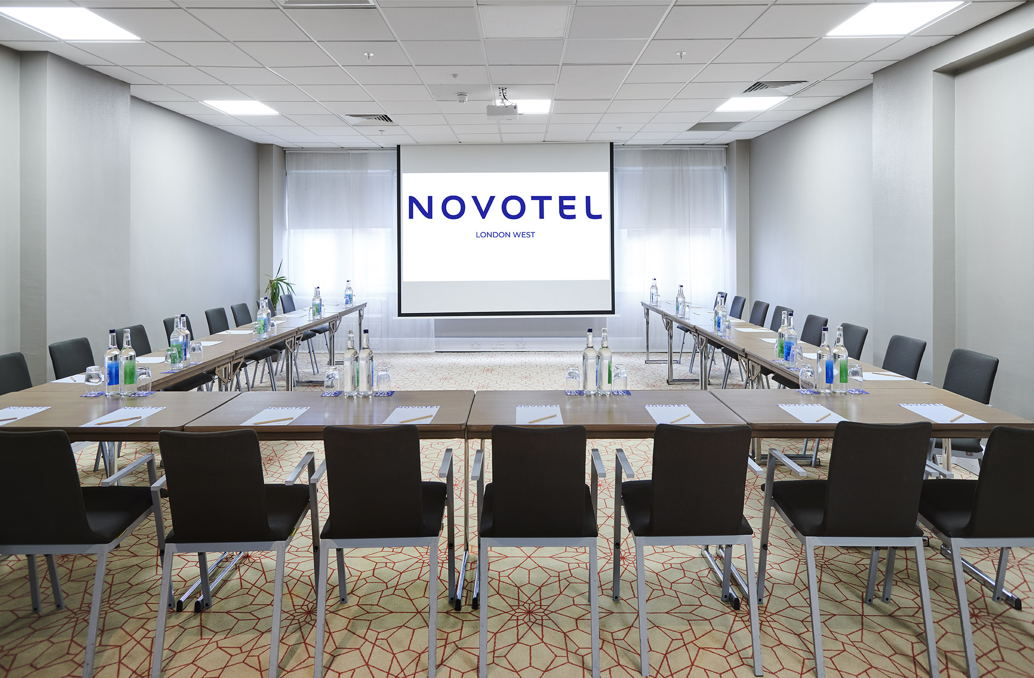 Corporate meeting room at Novotel London West with U-shaped layout and natural light.