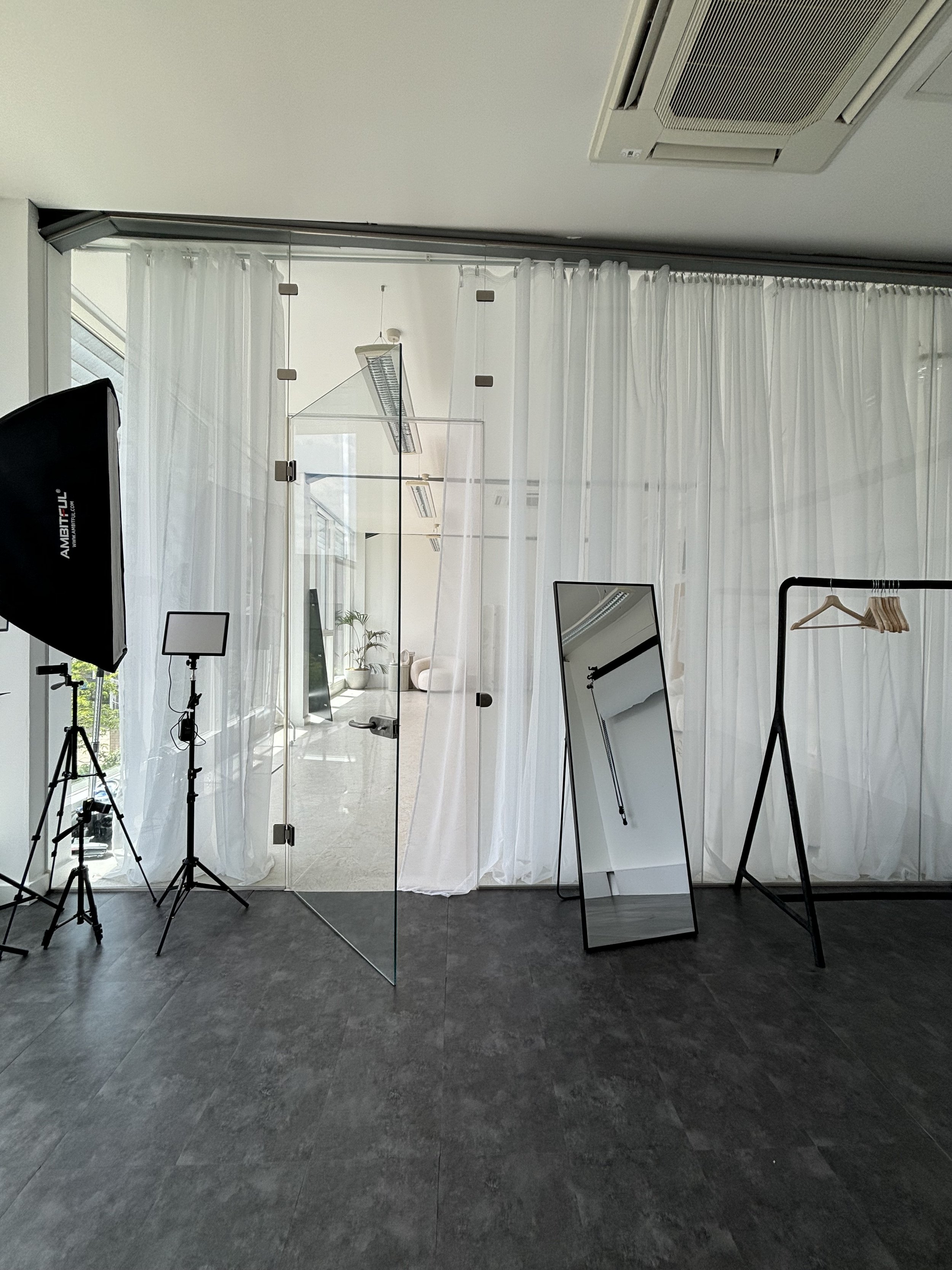 Versatile event space in Lounge Studios with sheer drapery and natural light for gatherings.