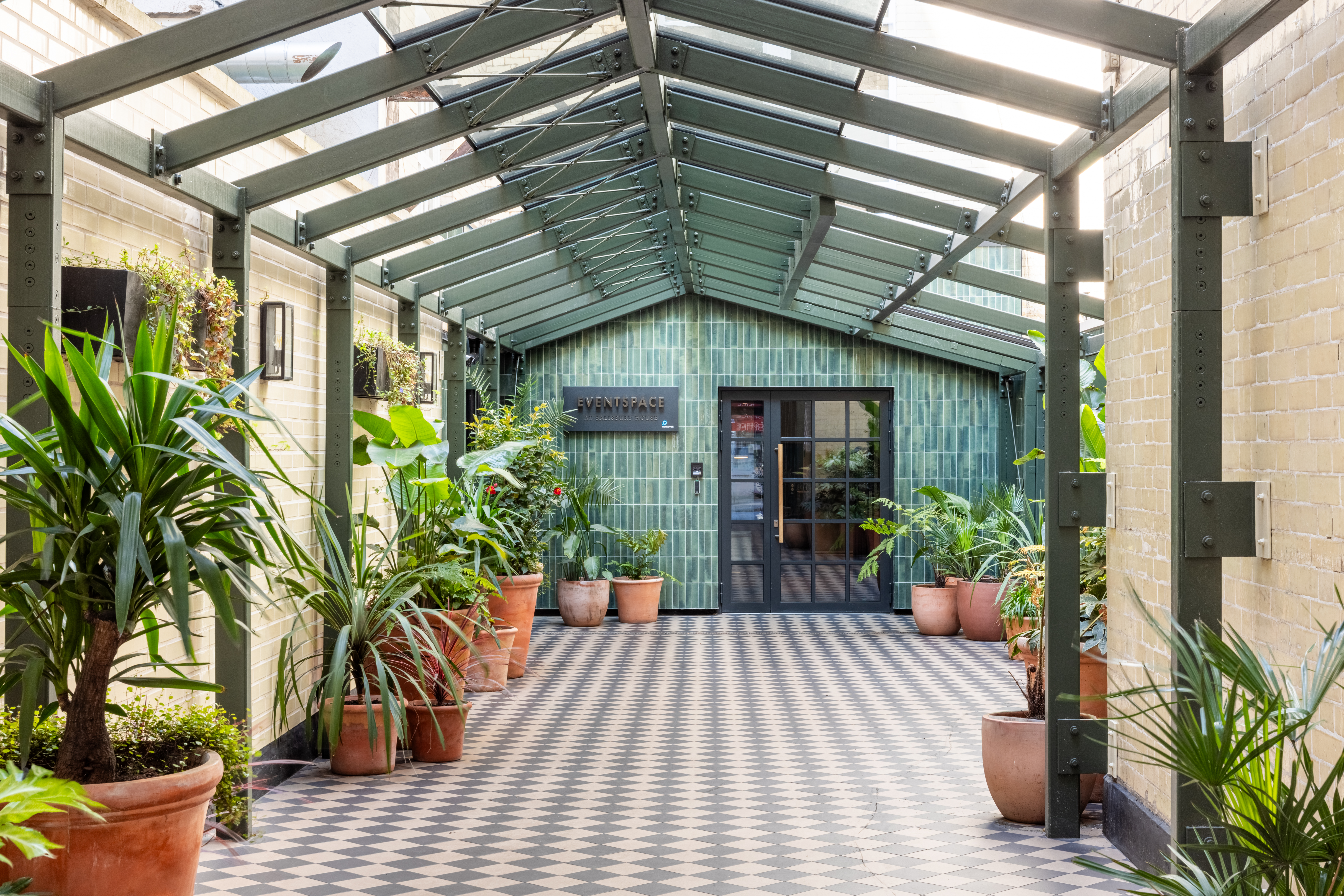 Inviting corridor at Salisbury House for events, featuring greenery and natural light.