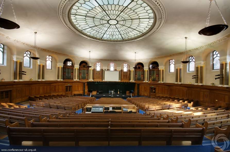 Elegant auditorium with stained glass, ideal for conferences and lectures.
