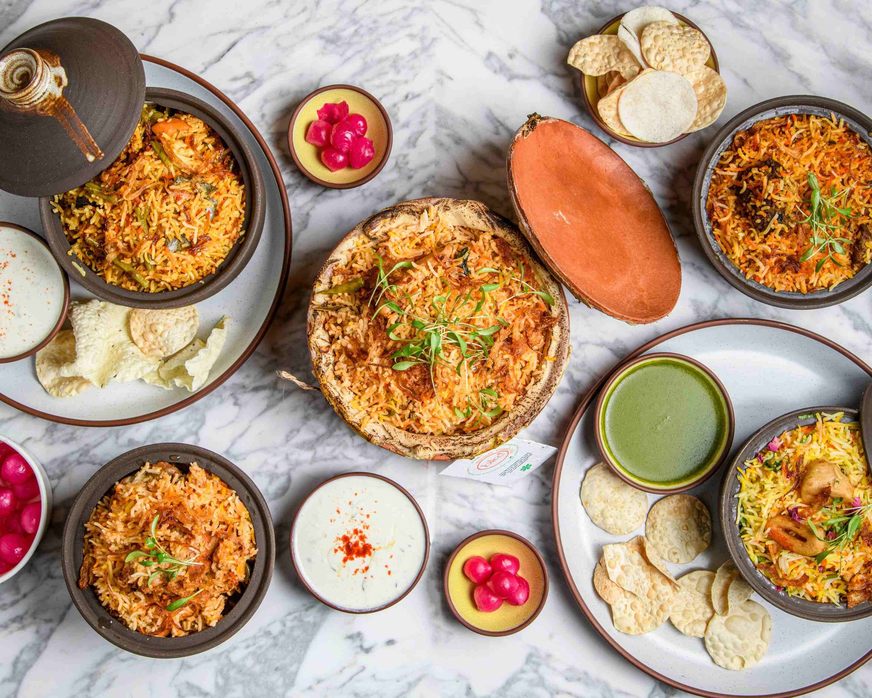 Biryani spread with raita and pickles, perfect for catering events and food gatherings.