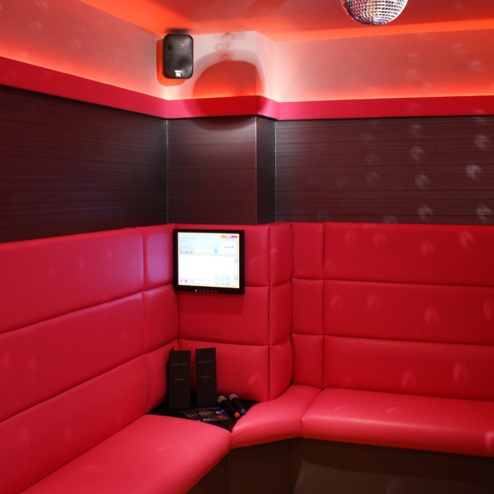 Cozy red meeting space in The Light Redhill for creative gatherings and brainstorming sessions.