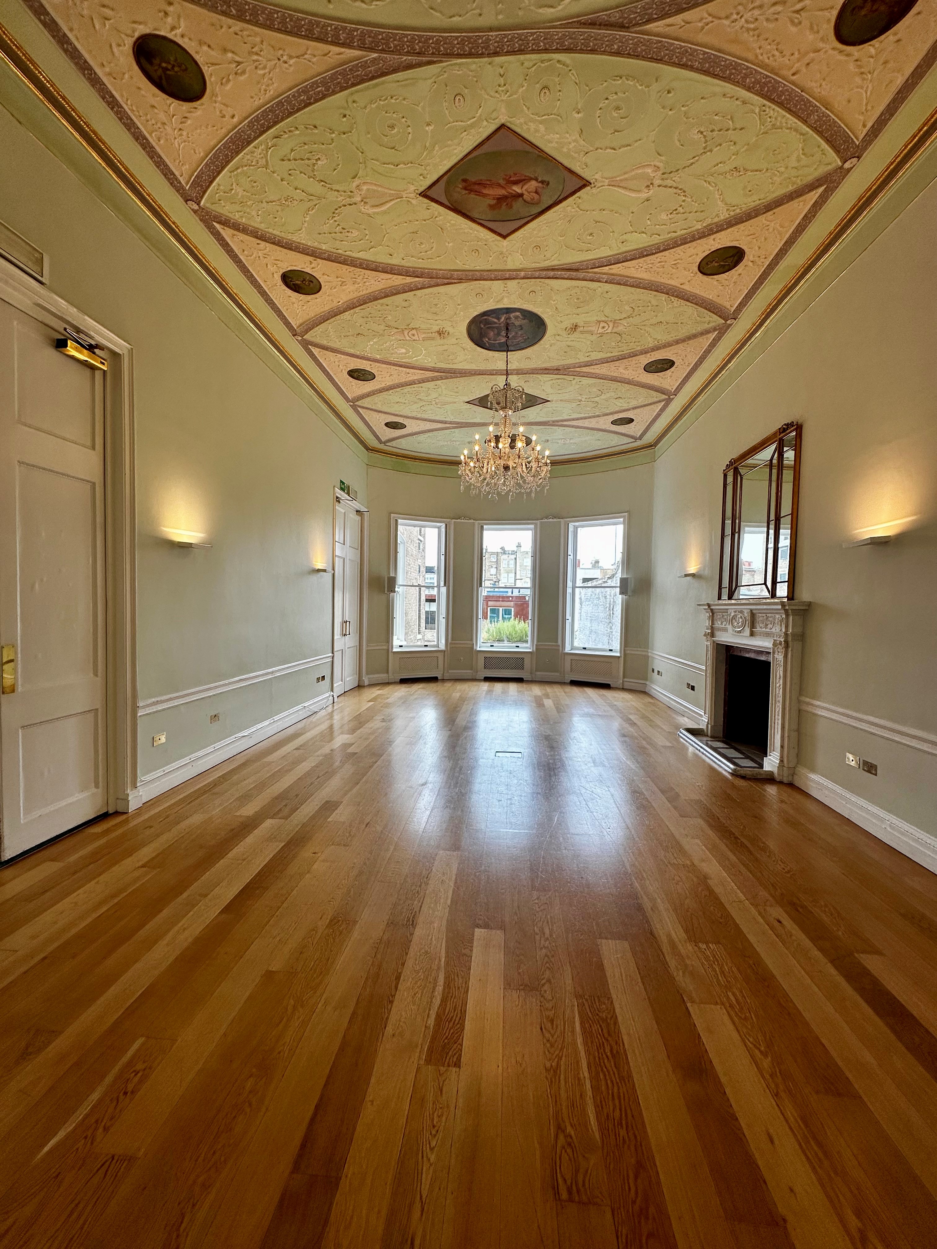 Elegant meeting room with high ceiling, ideal for workshops and networking events.