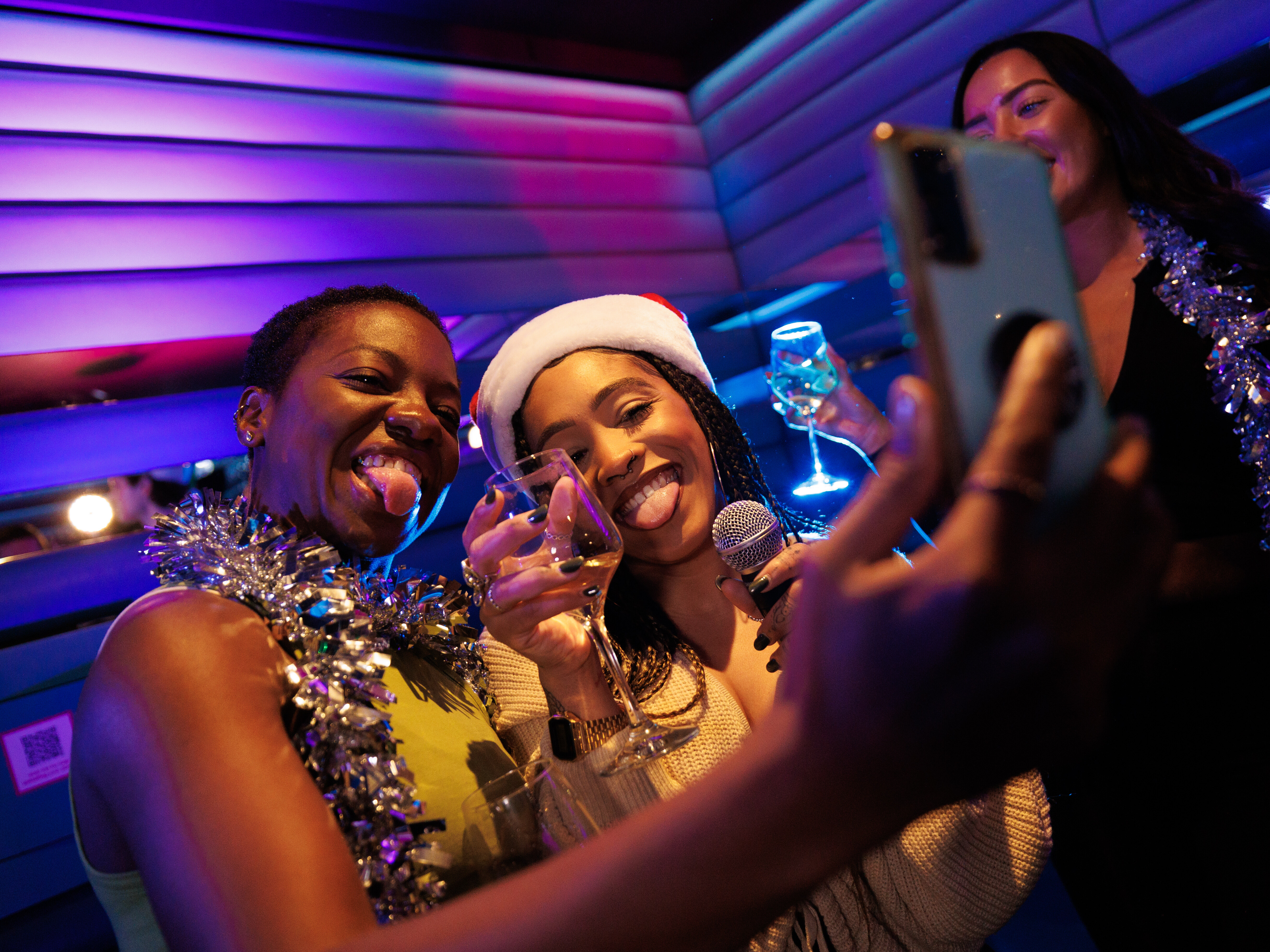 Christmas party at Lucky Voice Liverpool Street with festive decorations and joyful attendees.