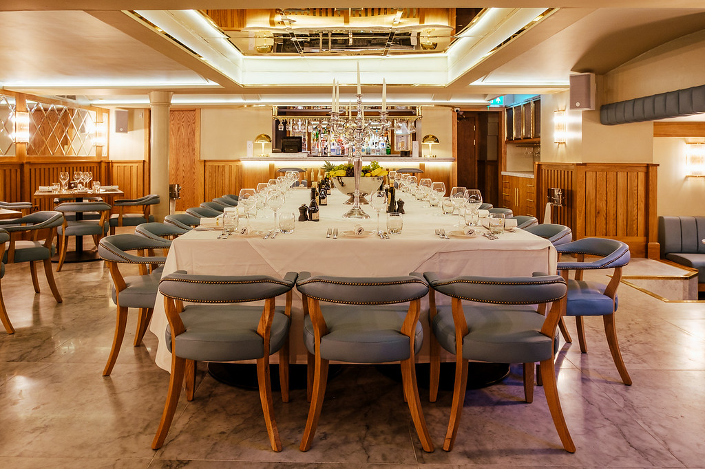 Elegant private dining room with long table, perfect for corporate events and gatherings.