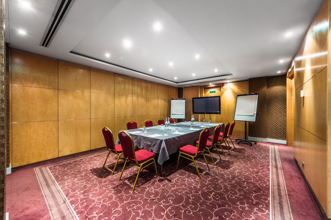 Meeting room at Courthouse Hotel with large table, ideal for workshops and presentations.