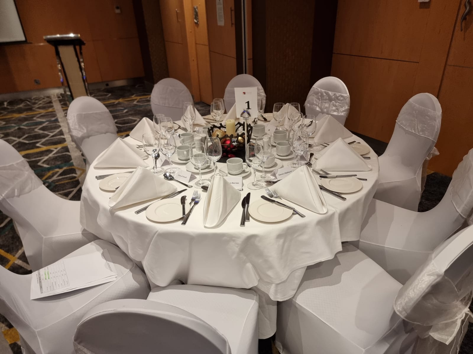 Elegant round table setup in Courthouse Hotel for a formal banquet or corporate event.
