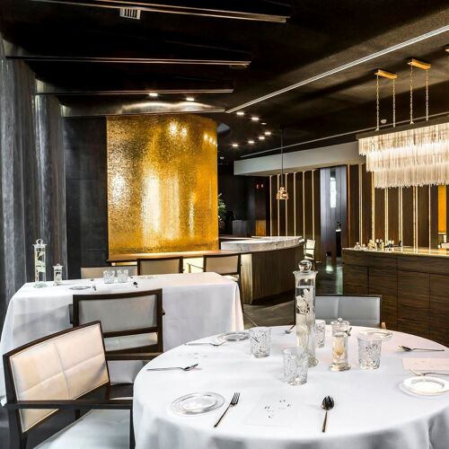 Sophisticated CEBO Restaurant with elegant gold wall, ideal for upscale events and corporate dinners.