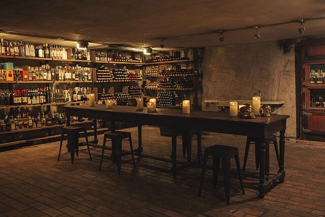 Rustic bar in Hidden Wine Cellar at Hotel Urban, perfect for cocktail receptions and gatherings.