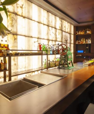Modern bar setup with illuminated wall at Khemer + Nut Room for events and receptions.