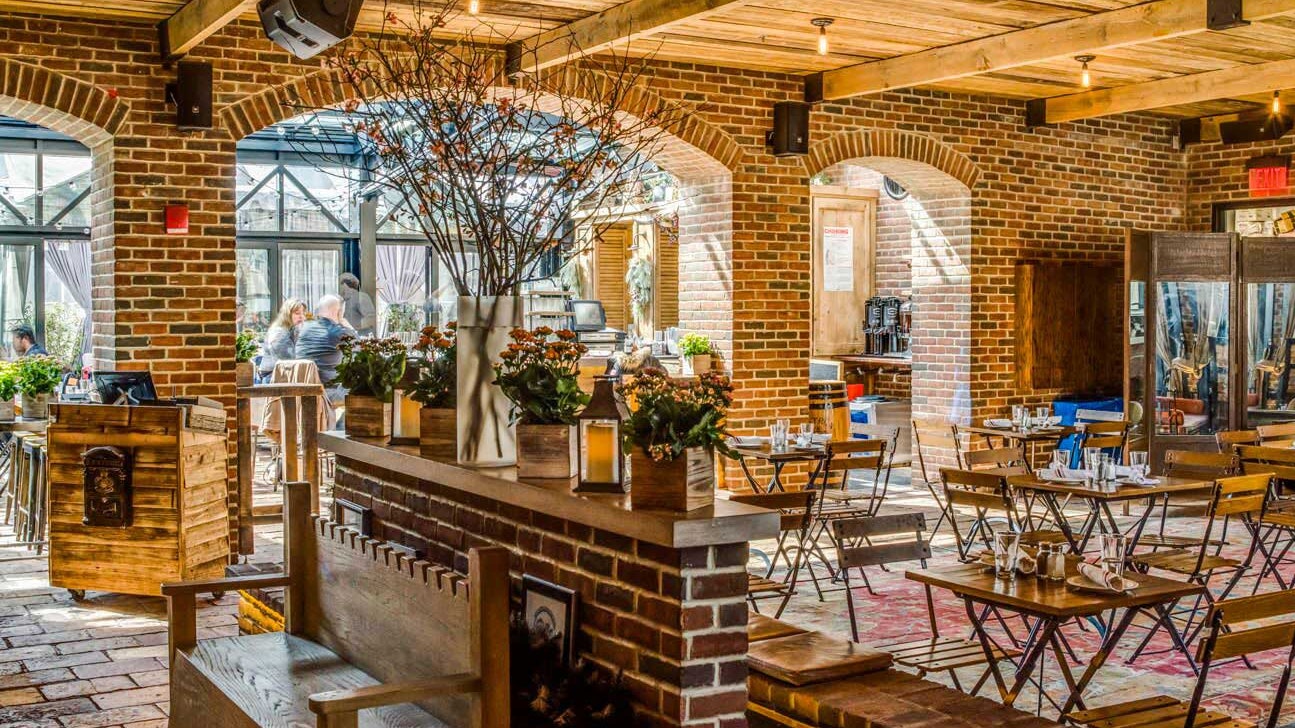 Rooftop Bar at Refinery Hotel: rustic venue with warm brick walls for corporate events.