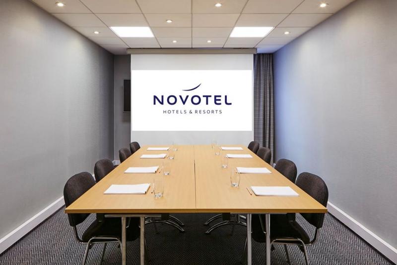 Modern meeting room at Novotel Manchester West for corporate events and presentations.