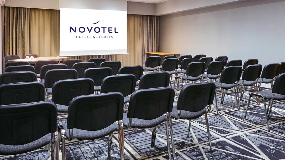 Modern meeting room at Novotel Manchester West for corporate events and presentations.