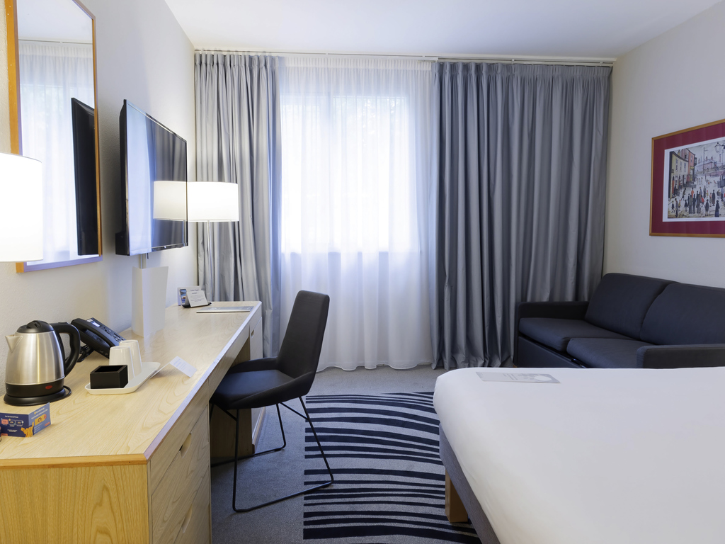 Meeting room at Novotel Manchester West with ergonomic workspace, perfect for corporate events.