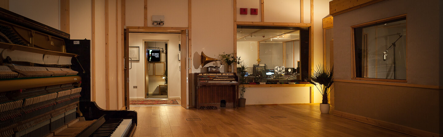 Stylish Voice Over Studios with wooden flooring for arts and entertainment events.