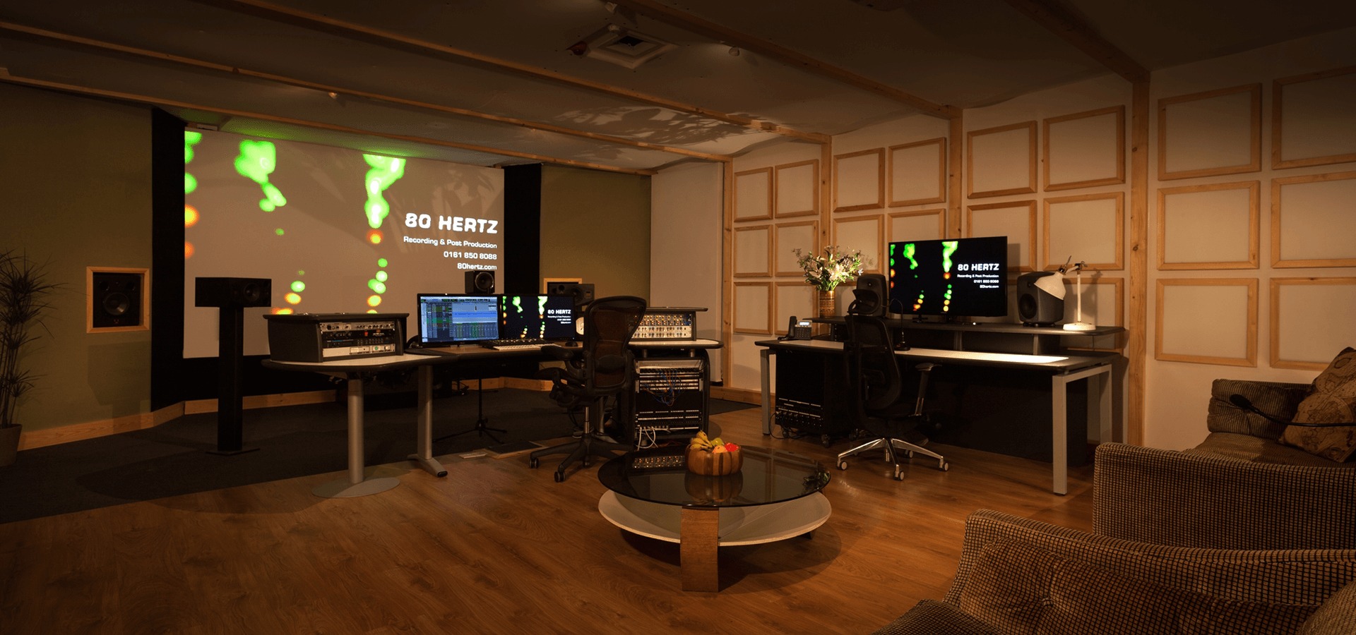 Modern event space at 80 Hertz Studio with multiple monitors for presentations.