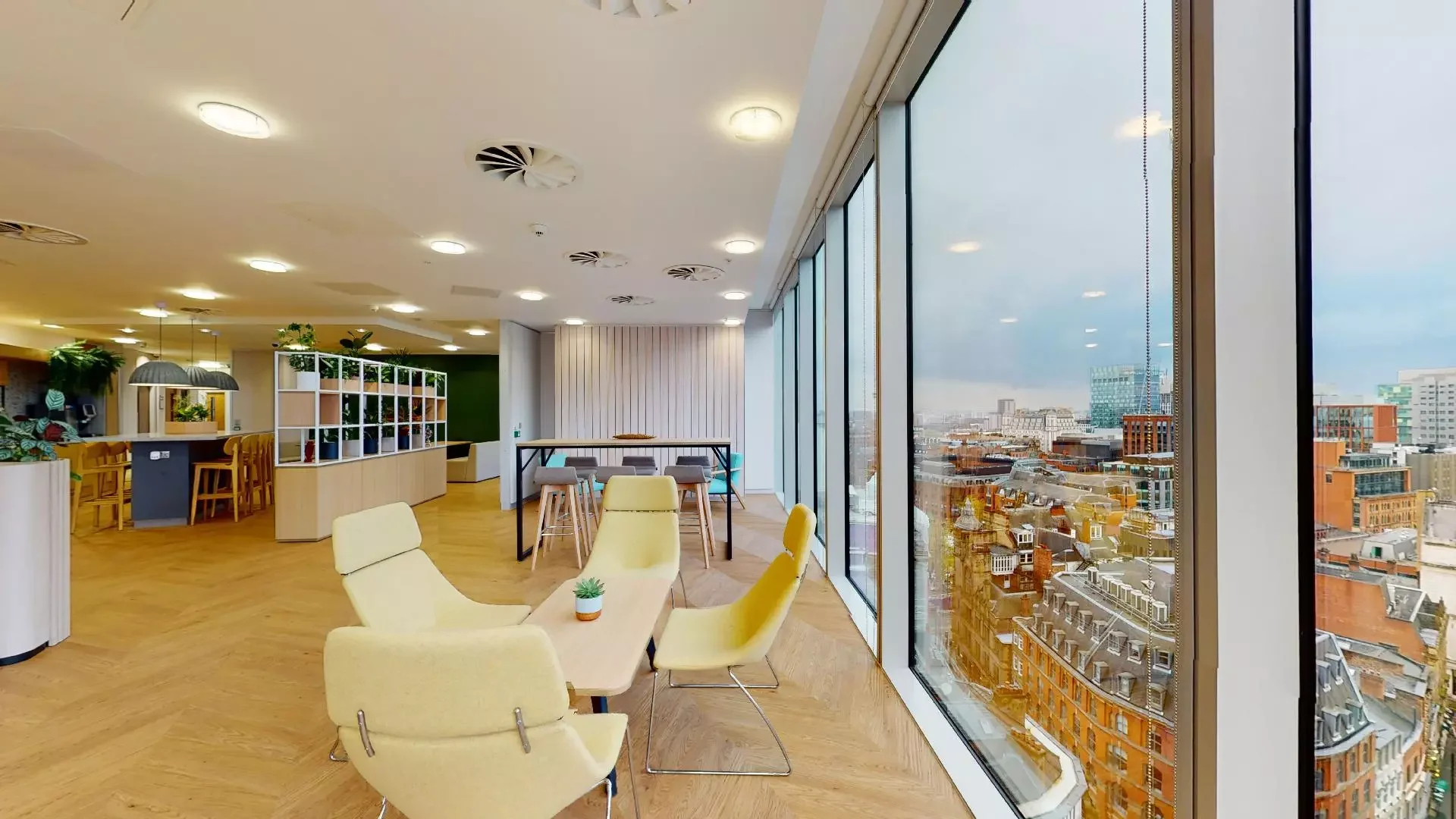 Modern coworking meeting space in Manchester with city views, ideal for workshops.